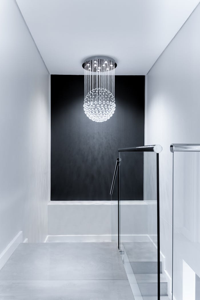 creative-02 Sleek contemporary hallway featuring a stunning glass chandelier and minimalist design.